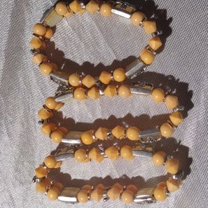 3 women orange beaded stretch bracelet